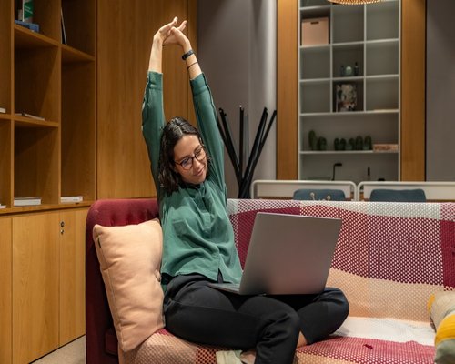 Person stretching at home office